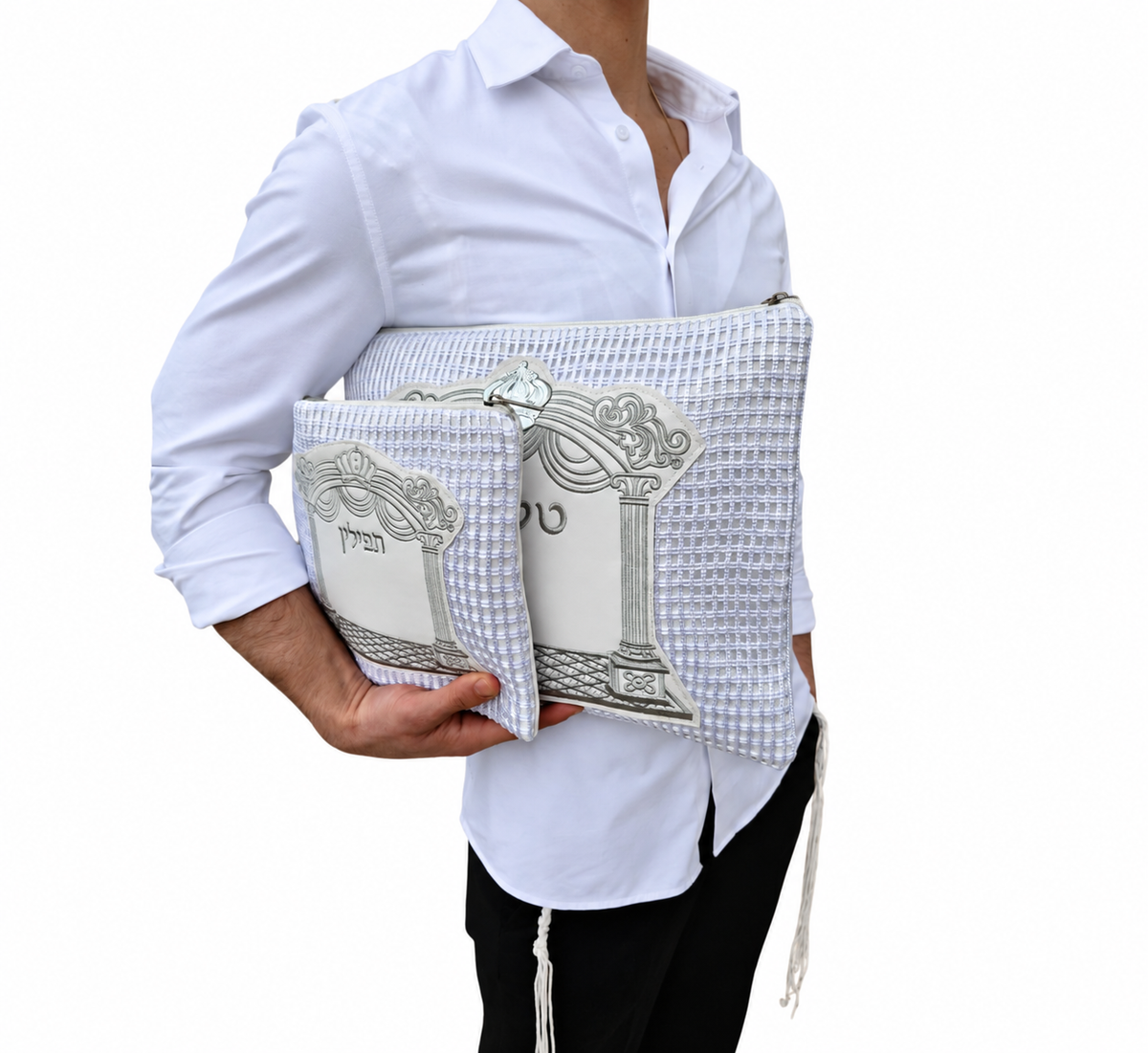 White faux leather tallit and tefillin bag set with silver pillars and arch embroidery labeled טלית and תפילין, front view on white background